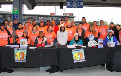 Volunteers at a sign-up booth for charity